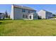 Exterior shot of backyard featuring a well-maintained lawn and partial view of the home at 14620 Hinton Dr, Fishers, IN 46037
