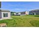 Large, well-maintained backyard with an outdoor structure, healthy lawn, and views of neighboring homes in the community at 14620 Hinton Dr, Fishers, IN 46037