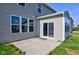 Exterior view of a concrete backyard patio with a sliding glass door entrance and nice green lawn at 14620 Hinton Dr, Fishers, IN 46037