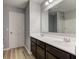 Well-lit bathroom featuring a double sink vanity, neutral walls, and plank flooring at 14620 Hinton Dr, Fishers, IN 46037