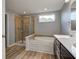 Bathroom featuring tiled shower, soaking tub, double vanity, and bright natural light at 14620 Hinton Dr, Fishers, IN 46037