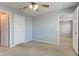 Bedroom featuring neutral carpet, ceiling fan, and multiple doorways for easy access at 14620 Hinton Dr, Fishers, IN 46037
