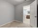 Bedroom with neutral colored walls, carpet, and access to a bathroom at 14620 Hinton Dr, Fishers, IN 46037