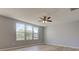 Bright bedroom features three large windows, ceiling fan, and wood-look flooring at 14620 Hinton Dr, Fishers, IN 46037
