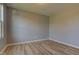 Bright, empty bedroom with wood floors, neutral walls, and a window at 14620 Hinton Dr, Fishers, IN 46037