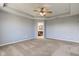 Large bedroom with neutral colored walls, carpet, and access to a bathroom at 14620 Hinton Dr, Fishers, IN 46037