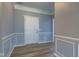 Welcoming entryway featuring paneled walls, light wood floors, and a white front door at 14620 Hinton Dr, Fishers, IN 46037