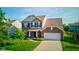 Inviting two-story home with brick and siding, featuring a well-manicured lawn and attached two-car garage at 14620 Hinton Dr, Fishers, IN 46037