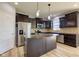 Beautiful kitchen with dark cabinetry, stainless steel appliances, a large island, and modern lighting at 14620 Hinton Dr, Fishers, IN 46037