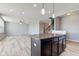 Kitchen island view showing open concept living space with hardwood floors and a ceiling fan at 14620 Hinton Dr, Fishers, IN 46037