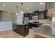 Well-equipped kitchen boasts dark cabinets, stainless steel appliances, a kitchen island, and stylish finishes at 14620 Hinton Dr, Fishers, IN 46037