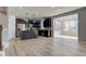 Modern kitchen features dark cabinets, stainless steel appliances, a large island, and wood-look flooring at 14620 Hinton Dr, Fishers, IN 46037