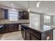 Bright kitchen boasts dark cabinets, granite countertops, tile backsplash, stainless steel appliances, and a center island at 14620 Hinton Dr, Fishers, IN 46037