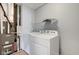 Laundry room with washing machine and dryer, shelving, and grey walls at 14620 Hinton Dr, Fishers, IN 46037