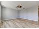 Spacious living room features wood-look floors, neutral paint, and modern ceiling fan at 14620 Hinton Dr, Fishers, IN 46037