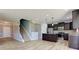Open concept living area showcasing wood floors, stairs, and kitchen with stainless steel appliances and a kitchen island at 14620 Hinton Dr, Fishers, IN 46037