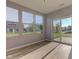 Bright sunroom with wood-look floors and sliding glass doors to backyard at 14620 Hinton Dr, Fishers, IN 46037