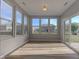 Bright sunroom with wood-look floors and large windows overlooking the backyard at 14620 Hinton Dr, Fishers, IN 46037