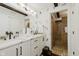 Charming bathroom featuring a double vanity, stylish fixtures, and a tiled shower with dog themed wallpaper at 1616 W 116Th St, Carmel, IN 46032