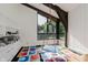 Bright bedroom with large windows and unique colorful floor tiles complemented by a hanging swing at 1616 W 116Th St, Carmel, IN 46032
