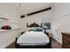 Cozy bedroom with wood beam, hardwood floors, and a decorative ceiling light fixture, offering a unique ambiance at 1616 W 116Th St, Carmel, IN 46032