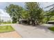 View of an exterior, with a spacious driveway surrounded by lush greenery, offering a serene setting at 1616 W 116Th St, Carmel, IN 46032