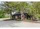A serene exterior view featuring a dark building surrounded by trees and a spacious driveway at 1616 W 116Th St, Carmel, IN 46032