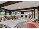 Spacious playroom with large windows, wood beams, a fireplace, and ample space for various activities and furniture at 1616 W 116Th St, Carmel, IN 46032