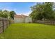 A spacious backyard with a well-maintained lawn and privacy fence surrounds a cozy home at 1730 S State Ave, Indianapolis, IN 46203