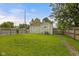 A spacious backyard with a well-maintained lawn and privacy fence surrounds a cozy home at 1730 S State Ave, Indianapolis, IN 46203