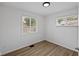 This light bedroom offers two windows and flooring at 1730 S State Ave, Indianapolis, IN 46203