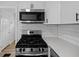 Updated kitchen featuring stainless steel appliances and quartz countertops at 1730 S State Ave, Indianapolis, IN 46203