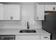 Close-up of the renovated kitchen featuring quartz countertops and white subway tile at 1730 S State Ave, Indianapolis, IN 46203