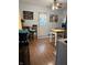 Cozy dining area with decorative wall hangings, wood flooring and a sheer curtain-covered door at 174 Jordan Dr, Franklin, IN 46131