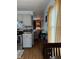Open kitchen flowing into living space, featuring gray cabinets, wood flooring, stainless steel appliances and ample lighting at 174 Jordan Dr, Franklin, IN 46131