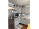 Well-maintained kitchen with gray cabinets, tiled backsplash, stainless steel refrigerator and countertops at 174 Jordan Dr, Franklin, IN 46131
