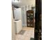 Well-organized laundry area with herringbone accent wall and tiled floors, adjacent to storage cabinet at 174 Jordan Dr, Franklin, IN 46131
