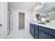 Bright bathroom featuring double vanity, large mirror, shower and tile flooring at 18980 Seaforth Way, Westfield, IN 46074