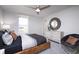 Comfortable bedroom featuring a ceiling fan, large window, bed, and stylish furnishings at 18980 Seaforth Way, Westfield, IN 46074