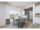 Cozy dining area with a light-colored wood table, gray chairs, and sliding glass doors to the outside at 18980 Seaforth Way, Westfield, IN 46074