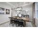 Bright dining room features a wooden table, modern chandelier, stylish decor, and a shiplap accent wall for a cozy feel at 18980 Seaforth Way, Westfield, IN 46074