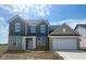 Beautiful two-story home with blue siding, stone accents, a two car garage, and a large front yard at 18980 Seaforth Way, Westfield, IN 46074