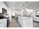 Well-lit kitchen featuring stainless steel appliances, an island with bar seating, and modern light fixtures at 18980 Seaforth Way, Westfield, IN 46074