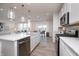 Open concept kitchen with an island and barstools overlooking the living and dining areas, and stainless appliances at 18980 Seaforth Way, Westfield, IN 46074