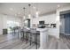 Stylish kitchen featuring stainless steel appliances, a large island with bar seating, and pendant lighting at 18980 Seaforth Way, Westfield, IN 46074