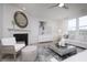 Cozy living room featuring a fireplace, a light-colored sofa, modern decor, and a decorative mirror and art at 18980 Seaforth Way, Westfield, IN 46074