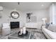 Chic living room featuring a fireplace, a light-colored sofa, and a decorative mirror and wall art at 18980 Seaforth Way, Westfield, IN 46074
