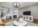 Bright and open living room with a fireplace, large windows, and contemporary decor at 18980 Seaforth Way, Westfield, IN 46074