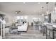 Bright open-concept living area with modern furnishings, a ceiling fan, and plenty of natural light at 18980 Seaforth Way, Westfield, IN 46074