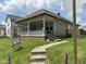 Charming home with a covered front porch, stone accents, and a well-maintained lawn at 1902 Westview Dr, Indianapolis, IN 46221